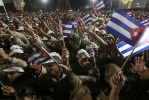 People wave Cuban flags as they attend a massive tribute to Cuba's late President Fidel Castro in Revolution Square in Havana, Cuba, November 29, 2016. REUTERS/Edgard Garrido
