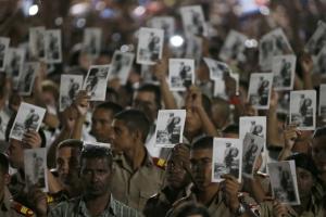 Cadets hold images of Cuba's late President Fidel Castro as they pay tribute to Castro at dusk at Revolution Square in Havana, Cuba, November 29, 2016. REUTERS/Carlos Garcia Rawlins